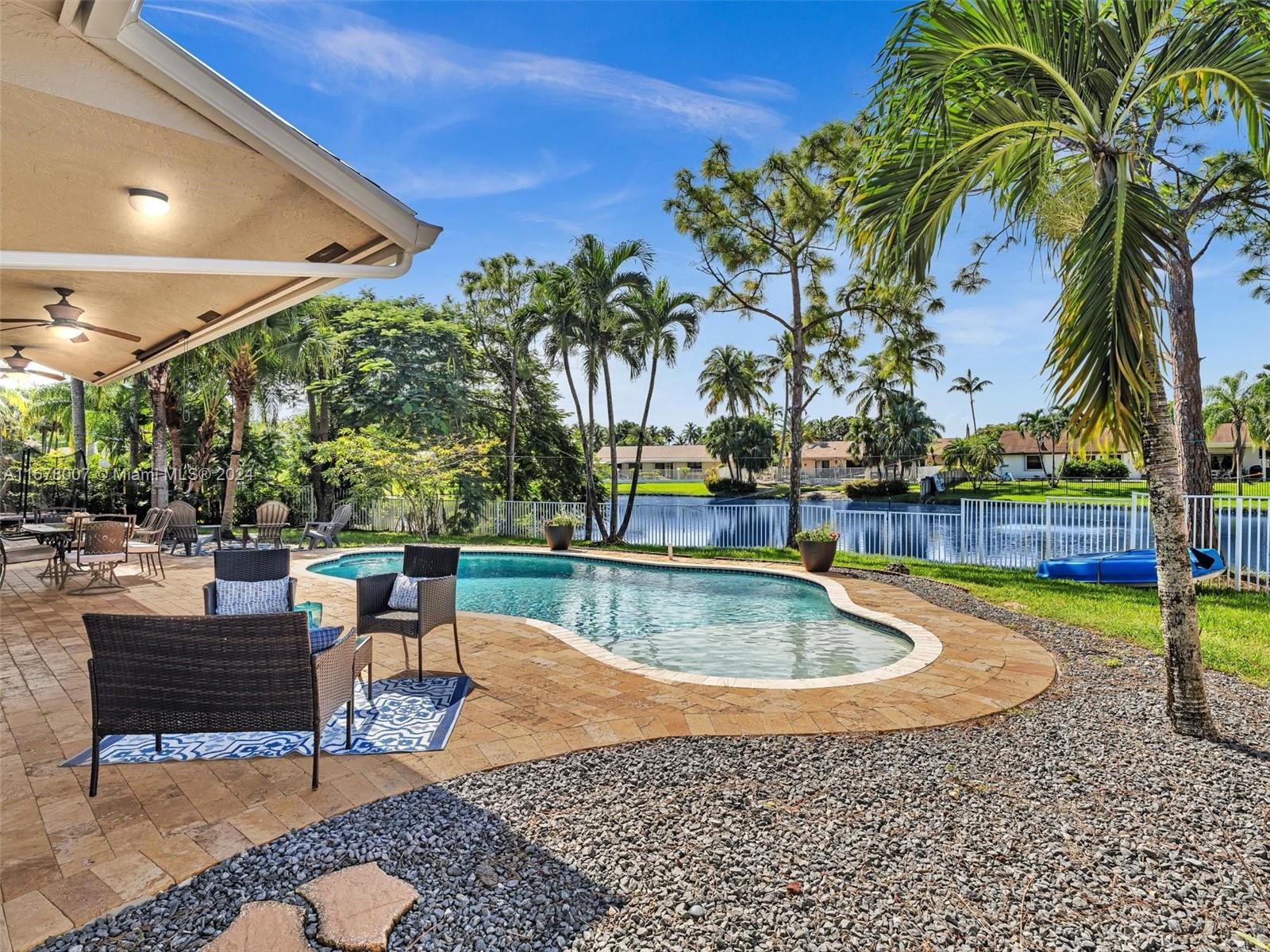 a view of a swimming pool with a table and chairs