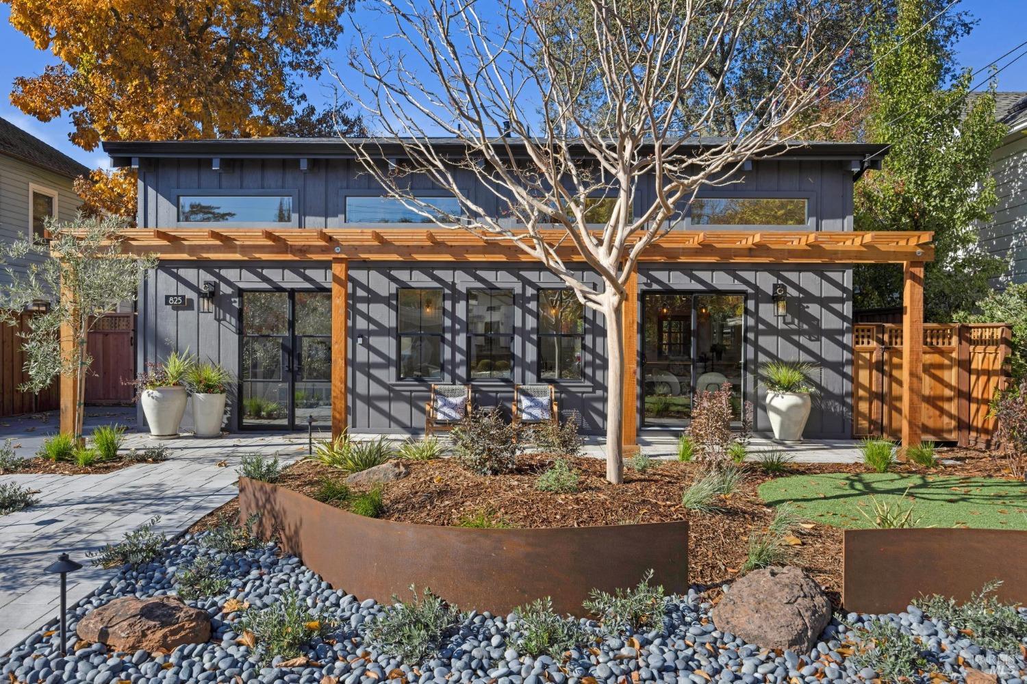 a view of a house with brick walls and a tree