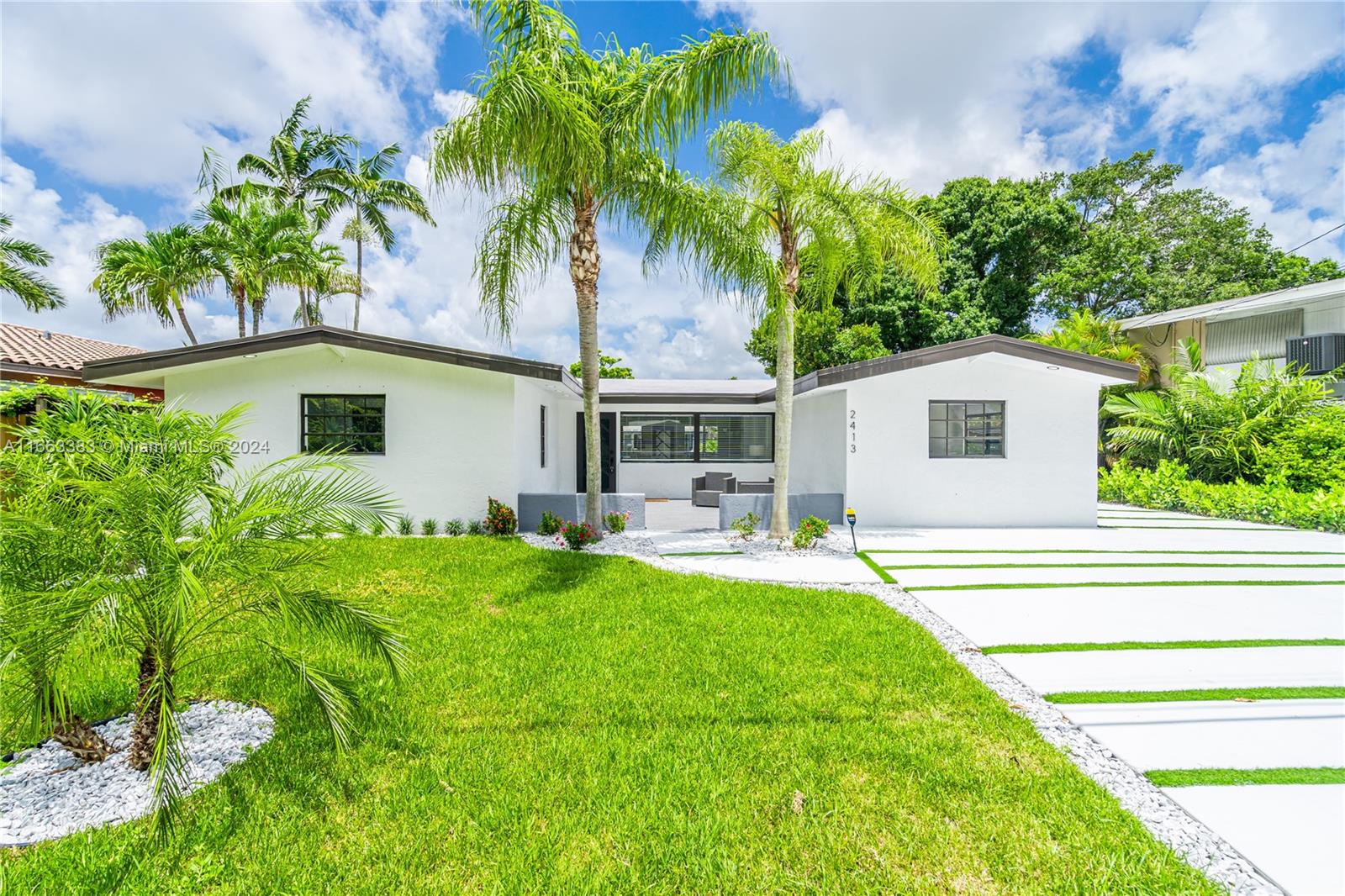 a front view of house with yard and outdoor seating