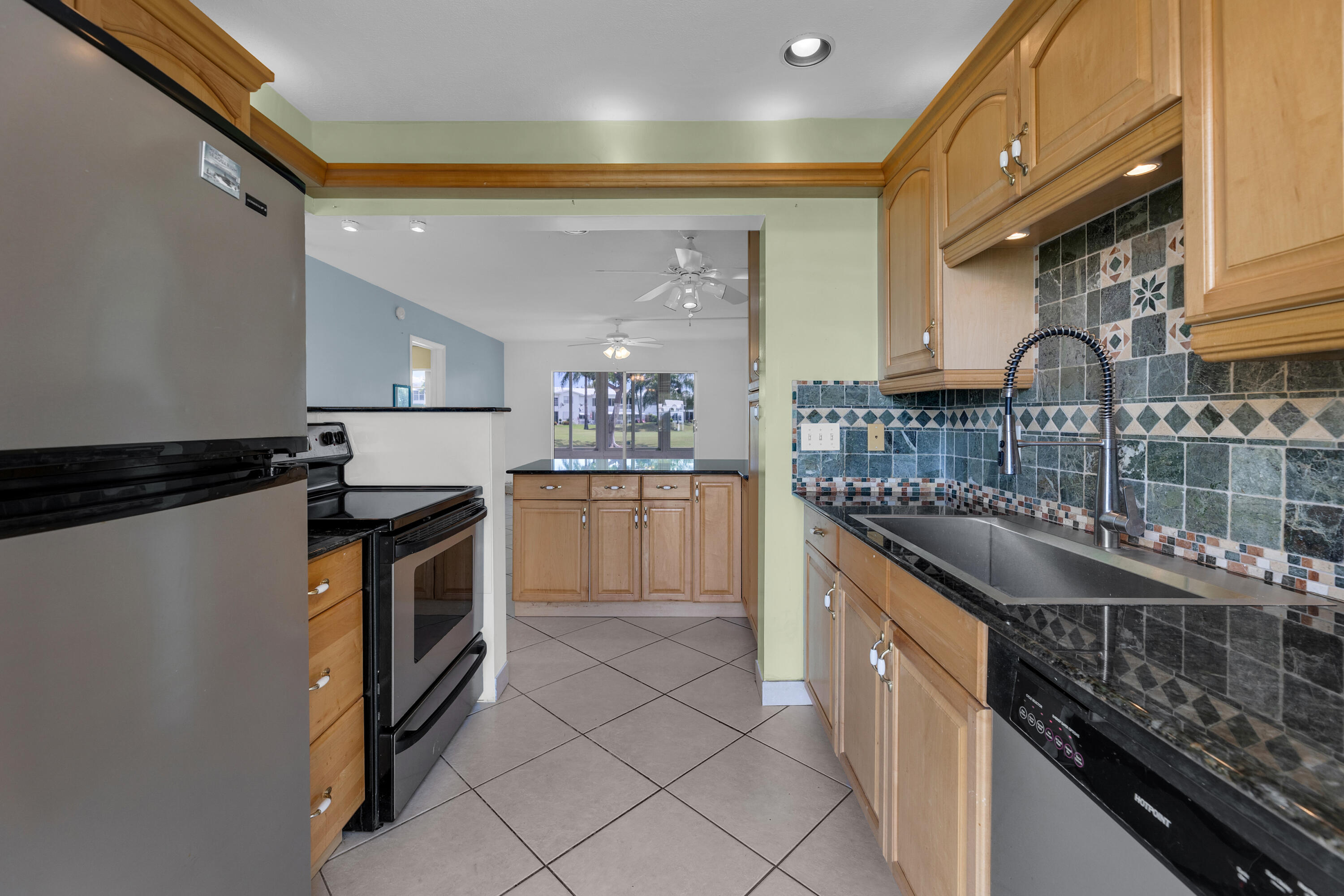 a kitchen with granite countertop a sink and a stove top oven