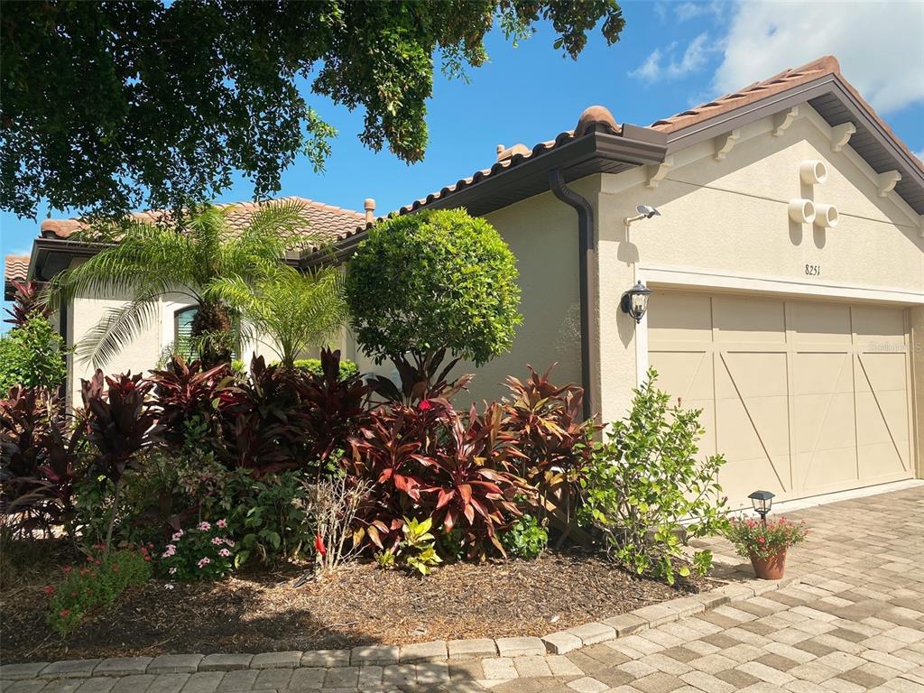 a view of a house with a flower garden