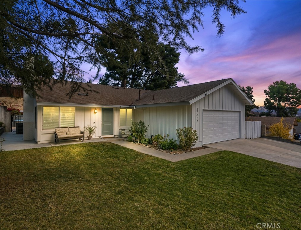 a view of a house with a yard and garage