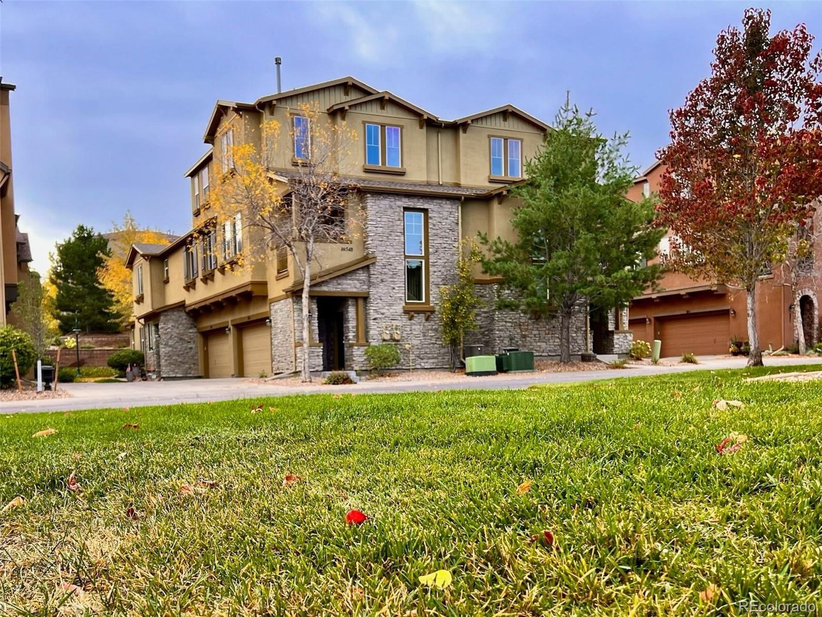 a front view of a house with a garden and plants