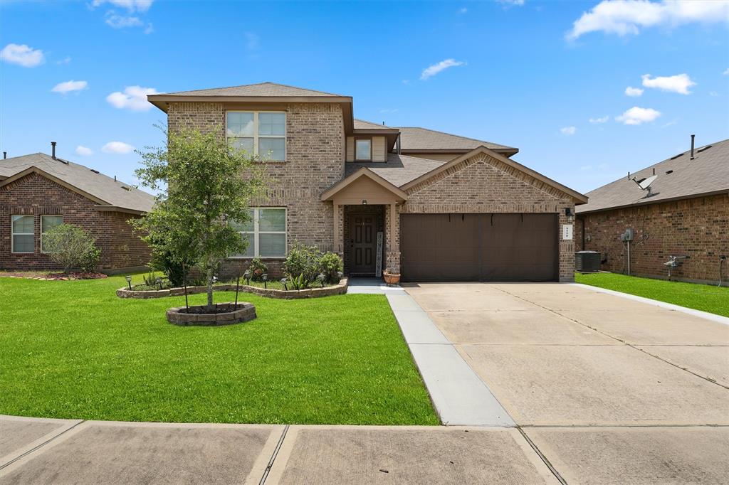 a front view of a house with a yard and garage