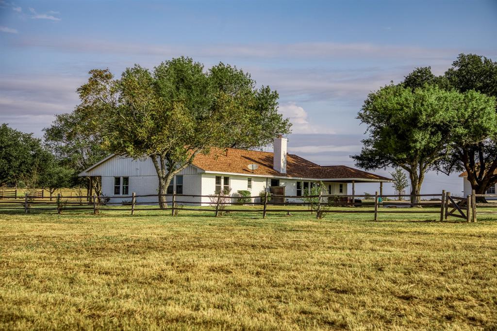 a front view of a house with a big yard