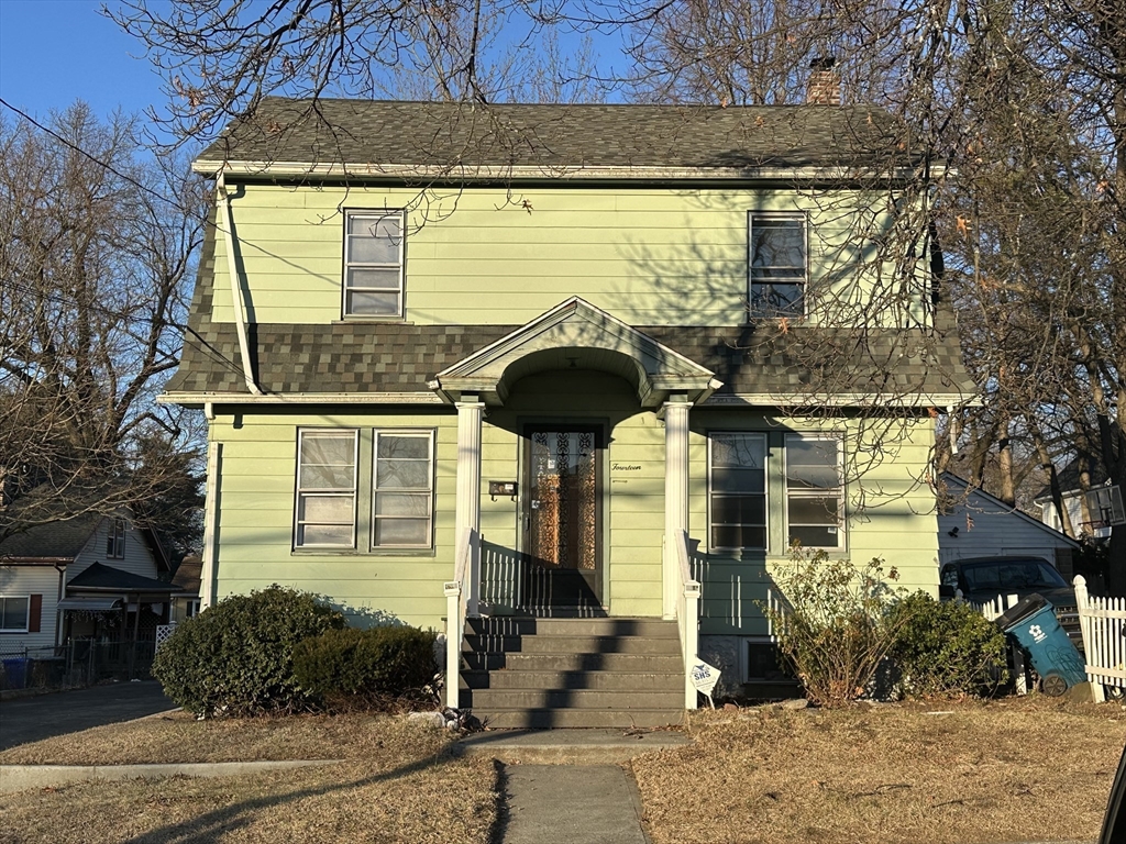 a front view of a house with a garden