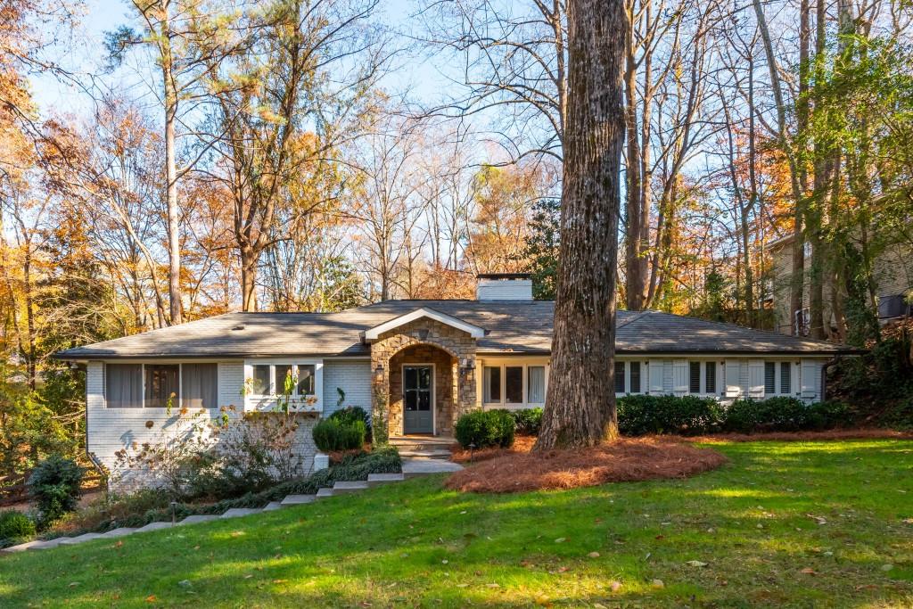 a front view of a house with a yard and porch