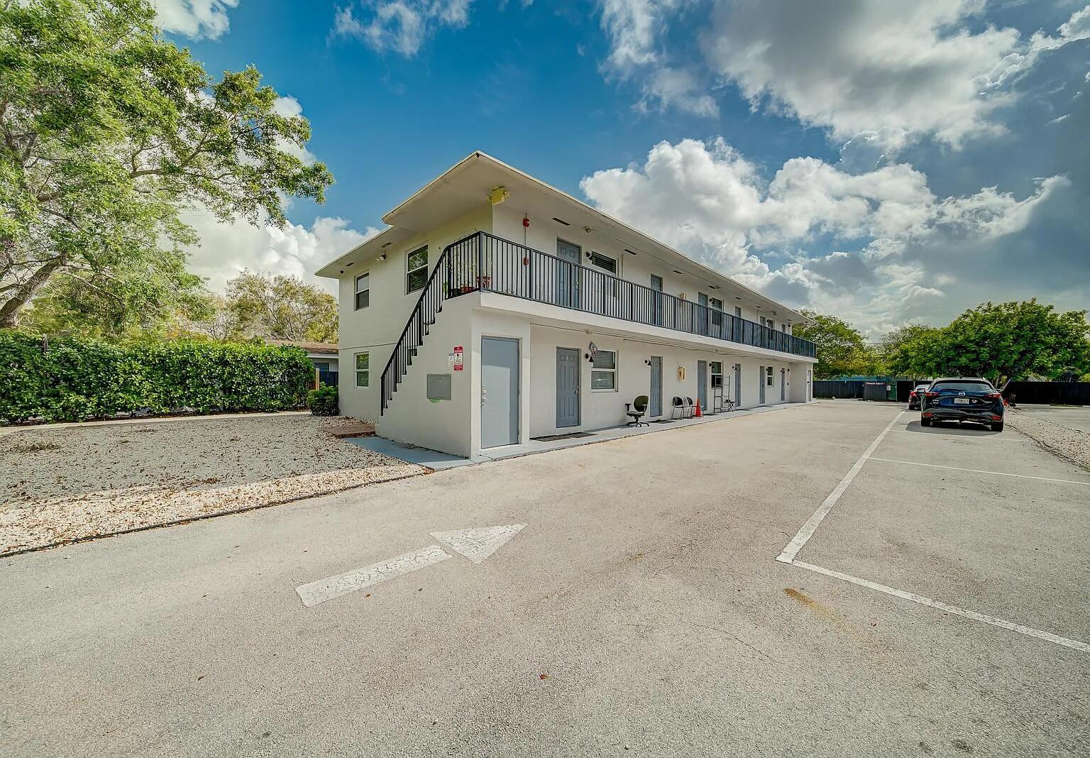 a view of a building with car parked