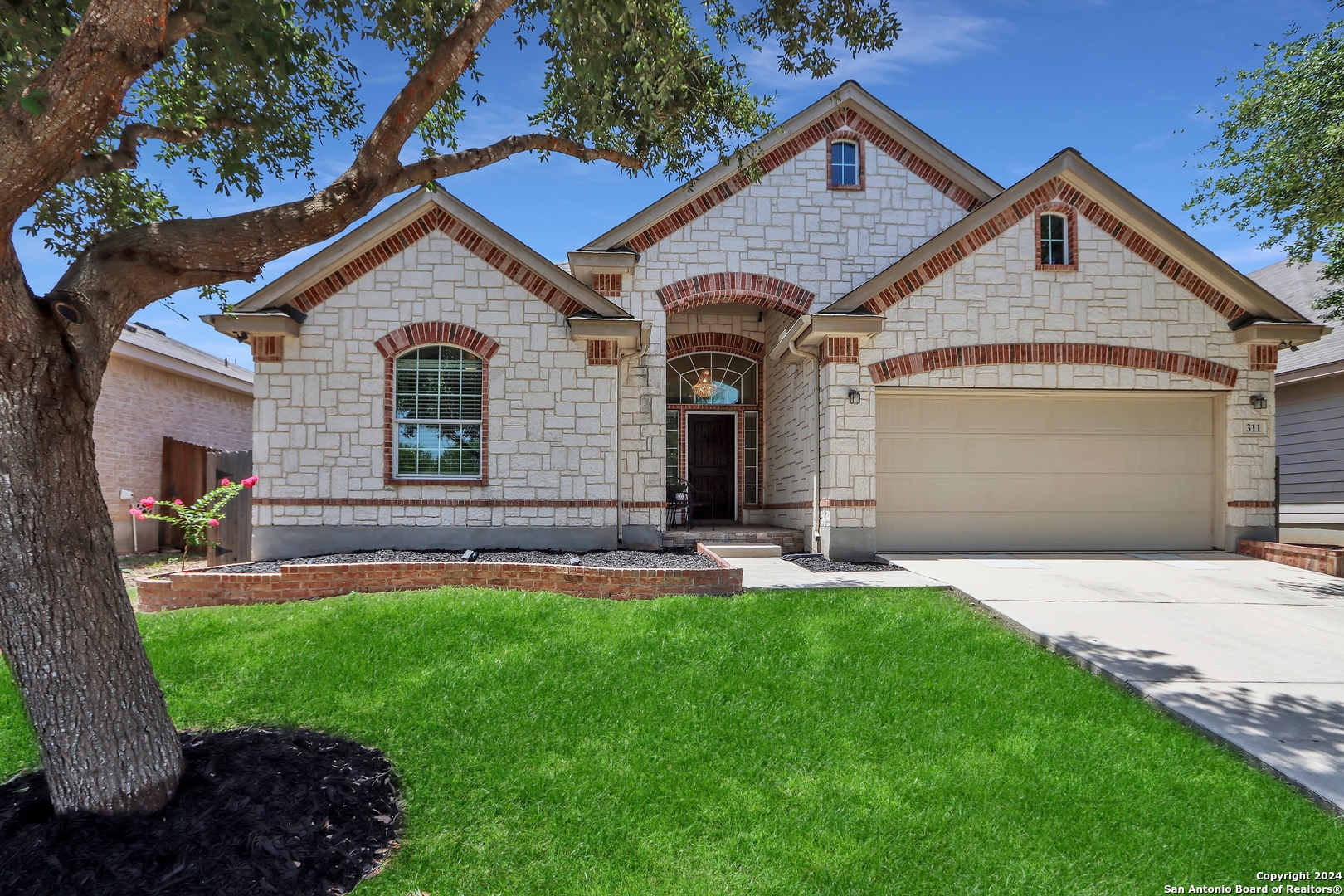 a front view of a house with a yard and garage