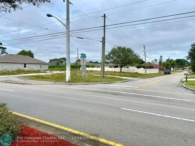 a view of a road with a big yard and plants