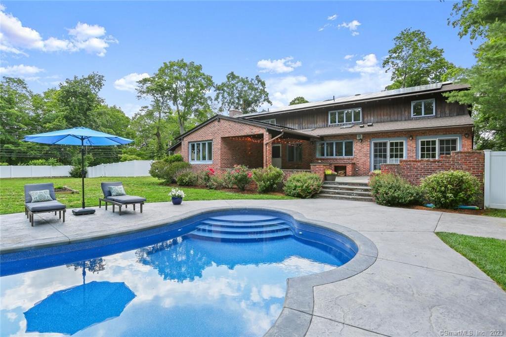 a front view of house with yard and outdoor seating