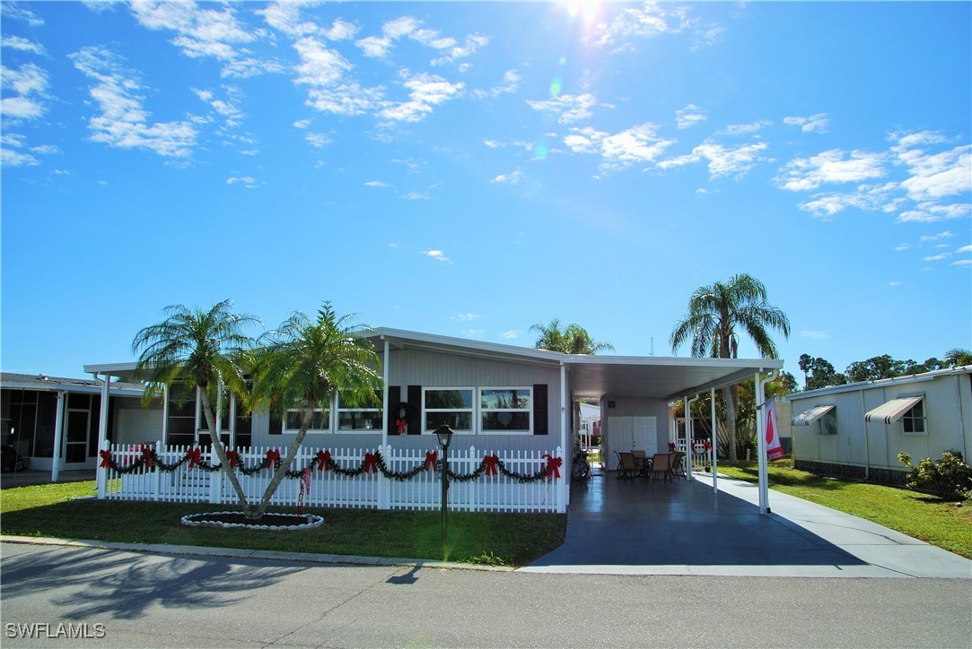 a front view of house with yard and outdoor seating