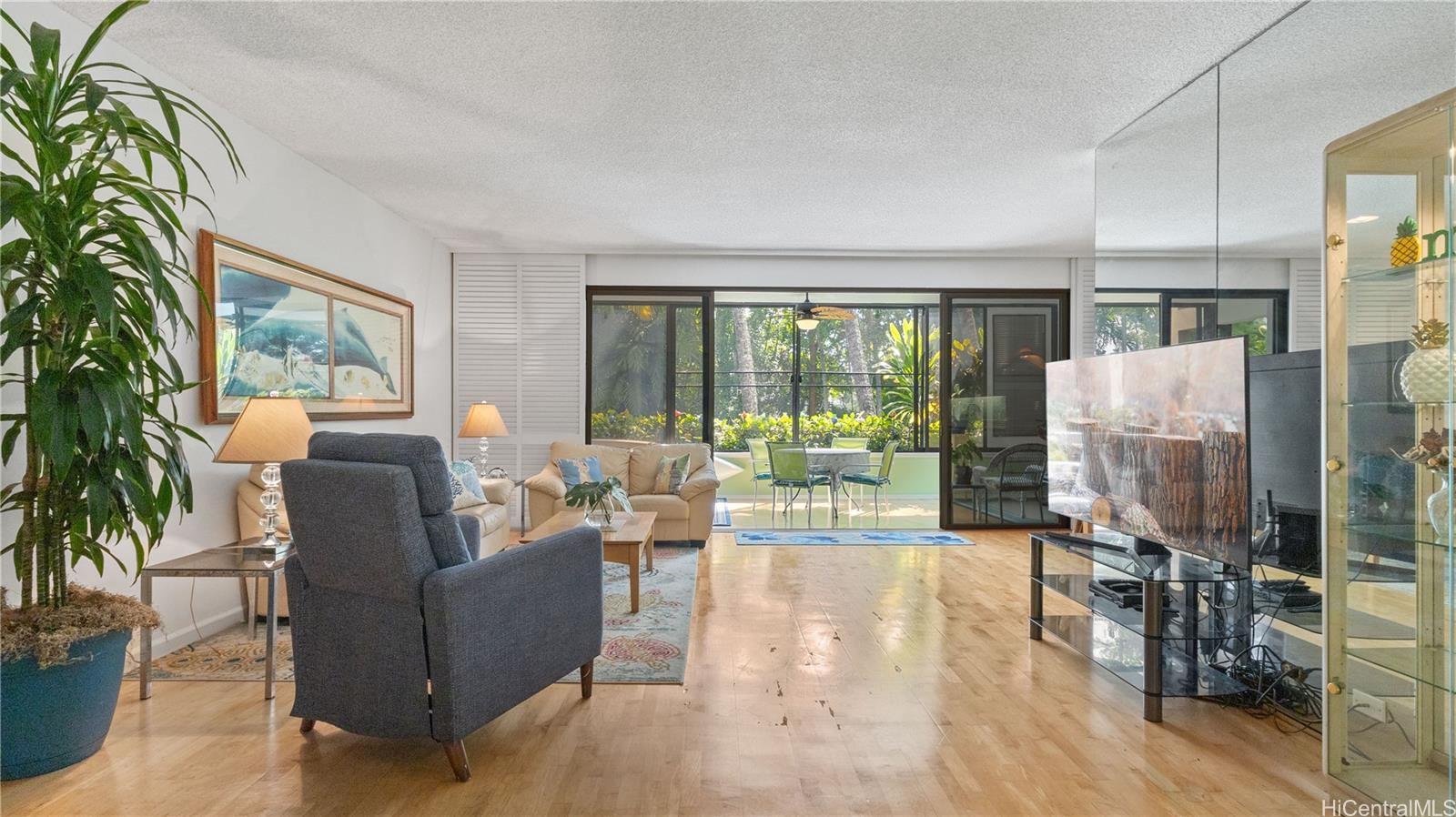 a living room with furniture and a floor to ceiling window