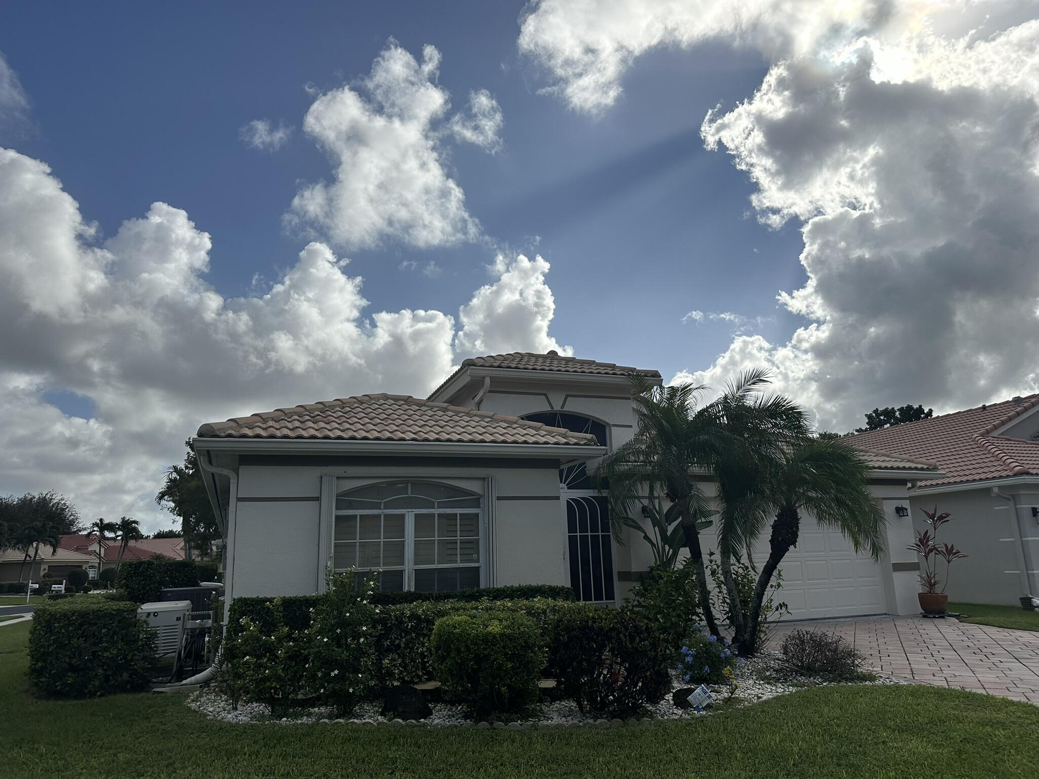 a view of a house with a yard and a fountain