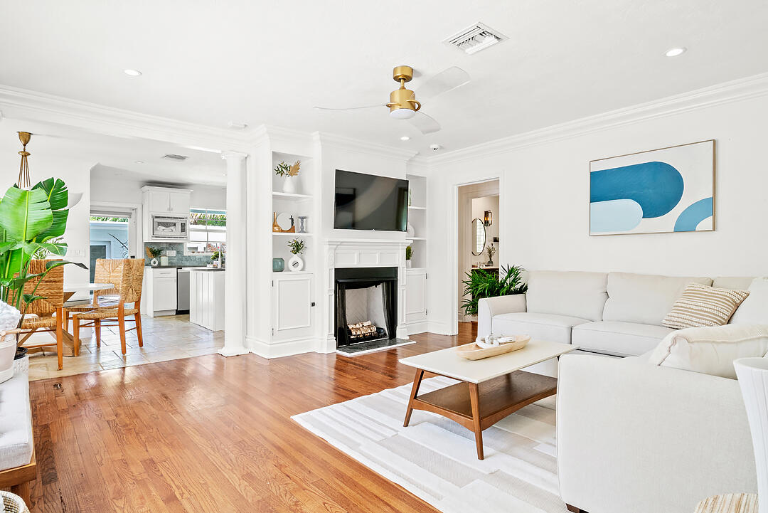 a living room with furniture a fireplace and a flat screen tv