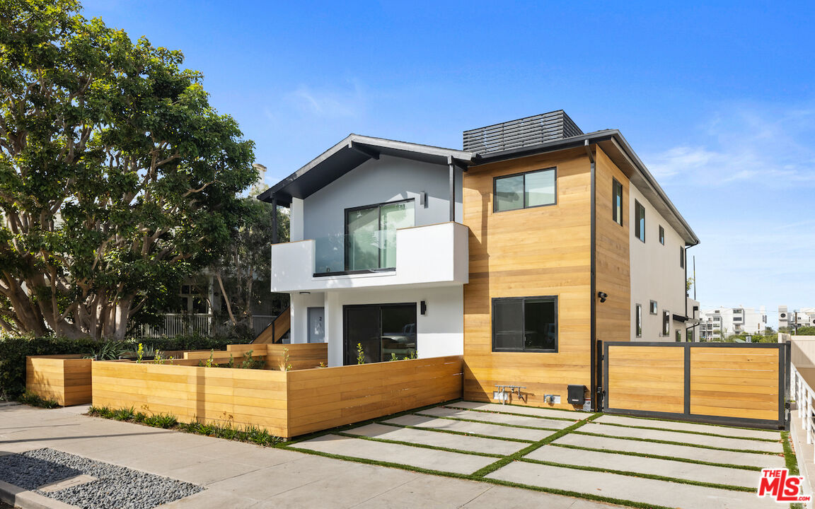 a front view of a house with glass windows and yard