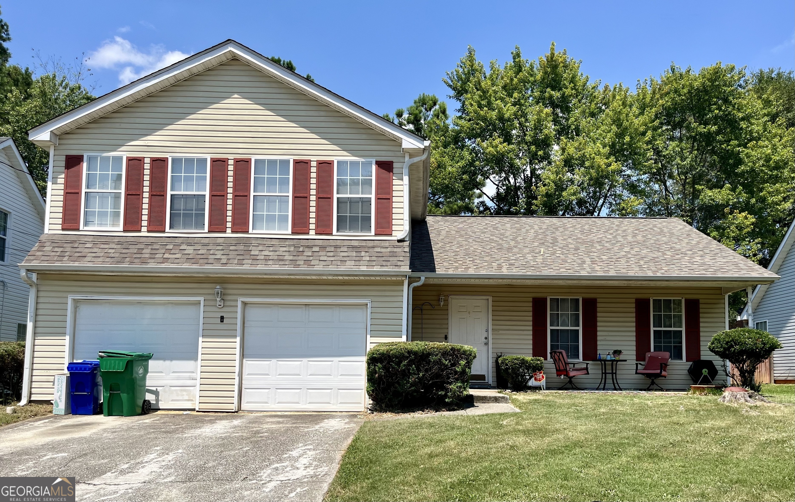 a front view of a house with a yard and porch