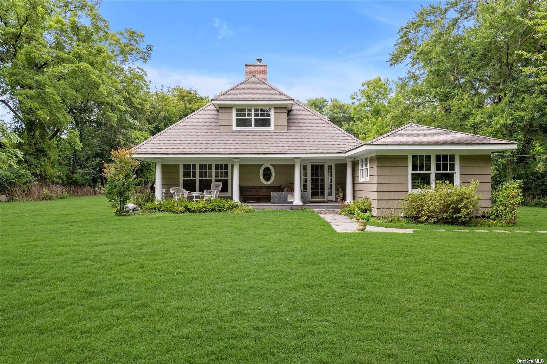 a front view of a house with a garden