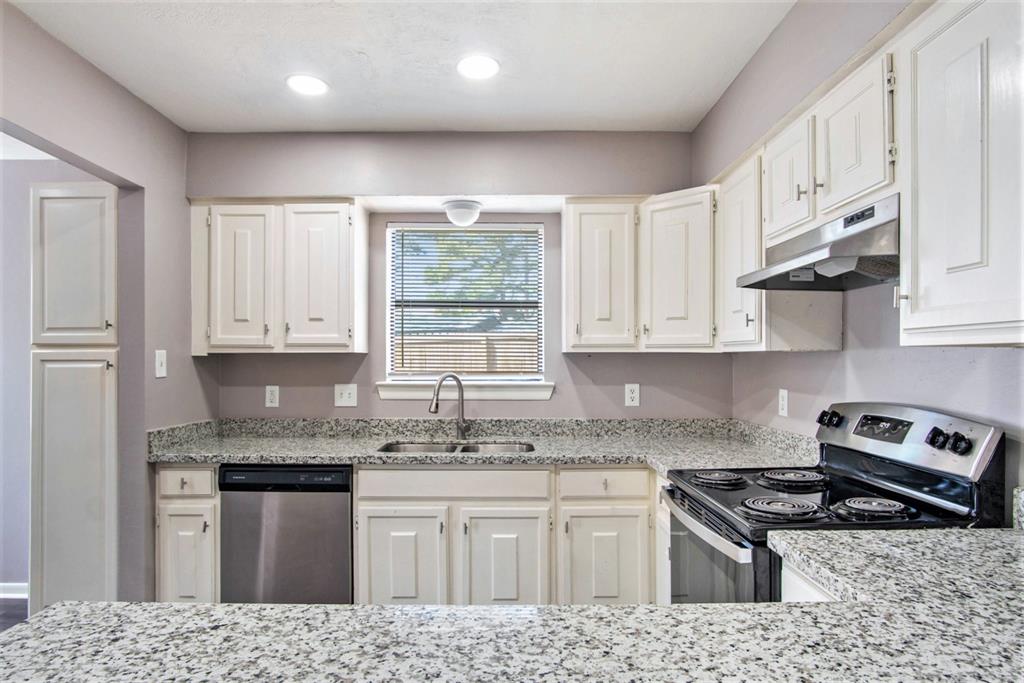 a kitchen with stainless steel appliances granite countertop a stove a sink and a granite counter tops