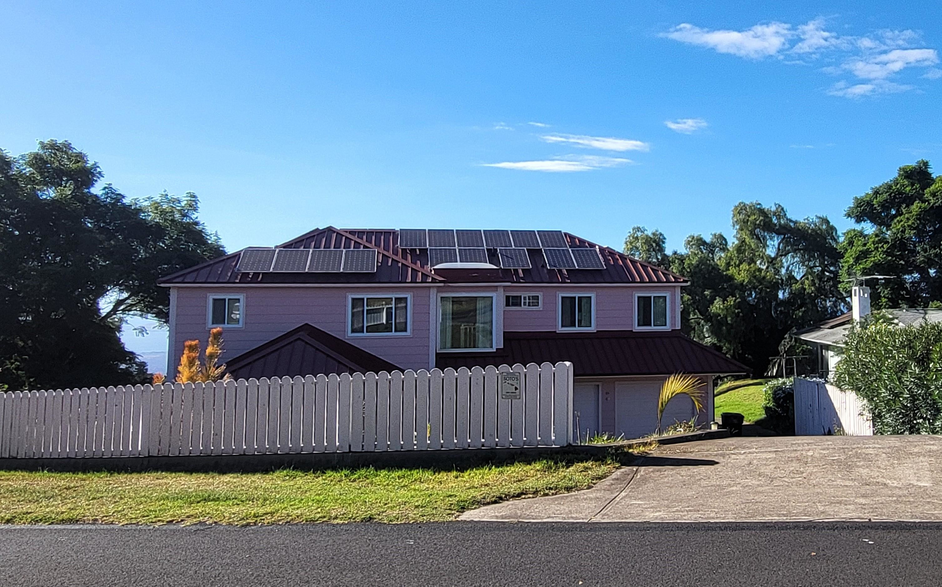 a view of a house with a yard and plants