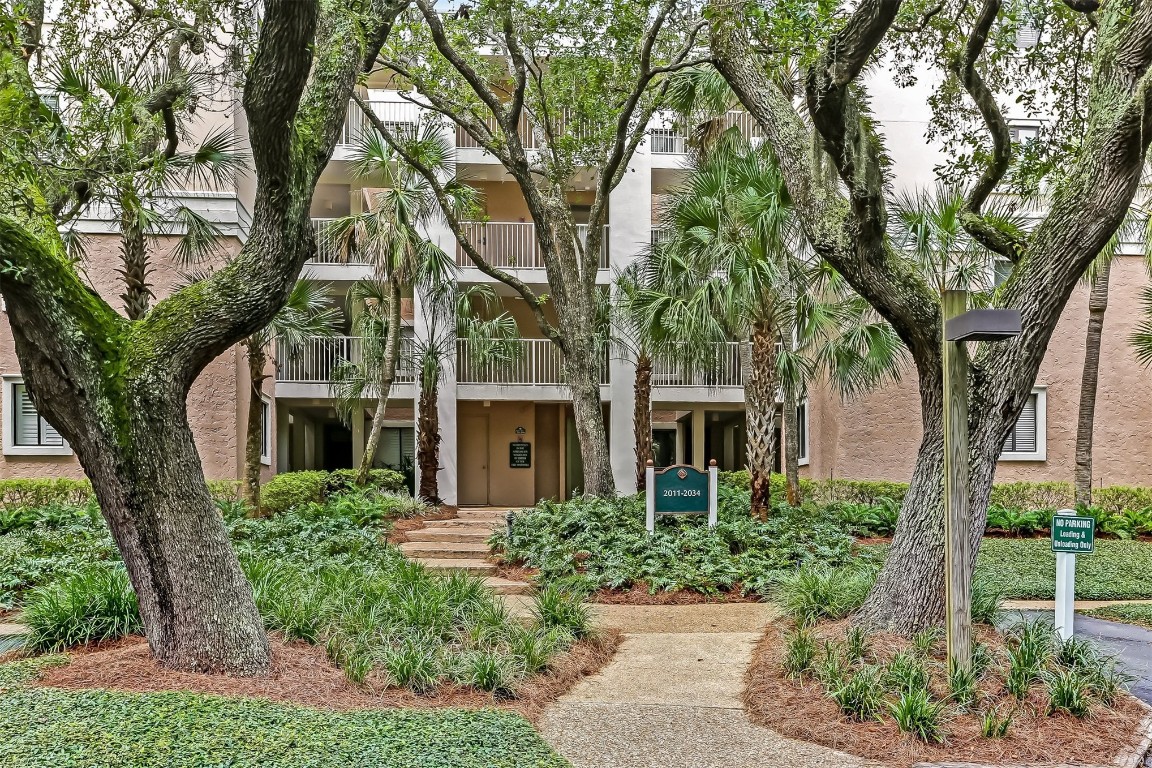 a front view of a house with yard and green space