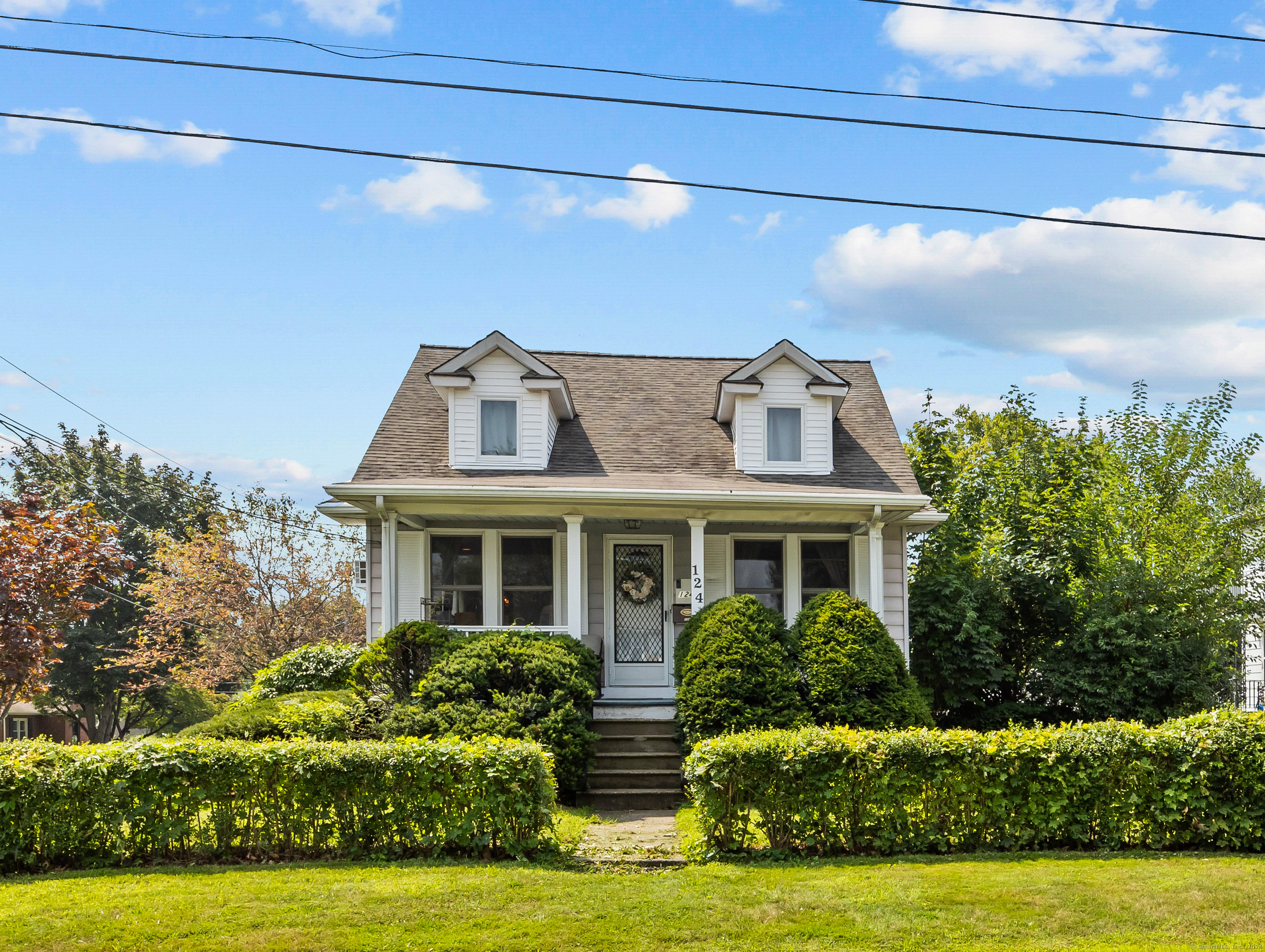 a front view of house with yard and green space