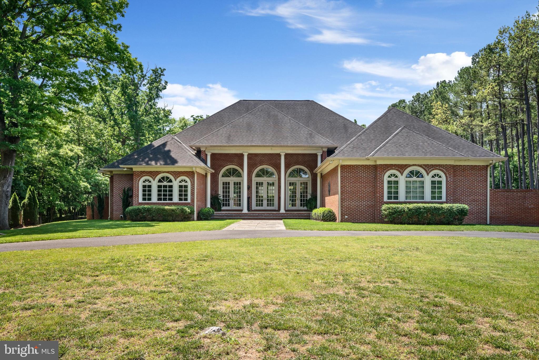 a front view of a house with a yard and porch