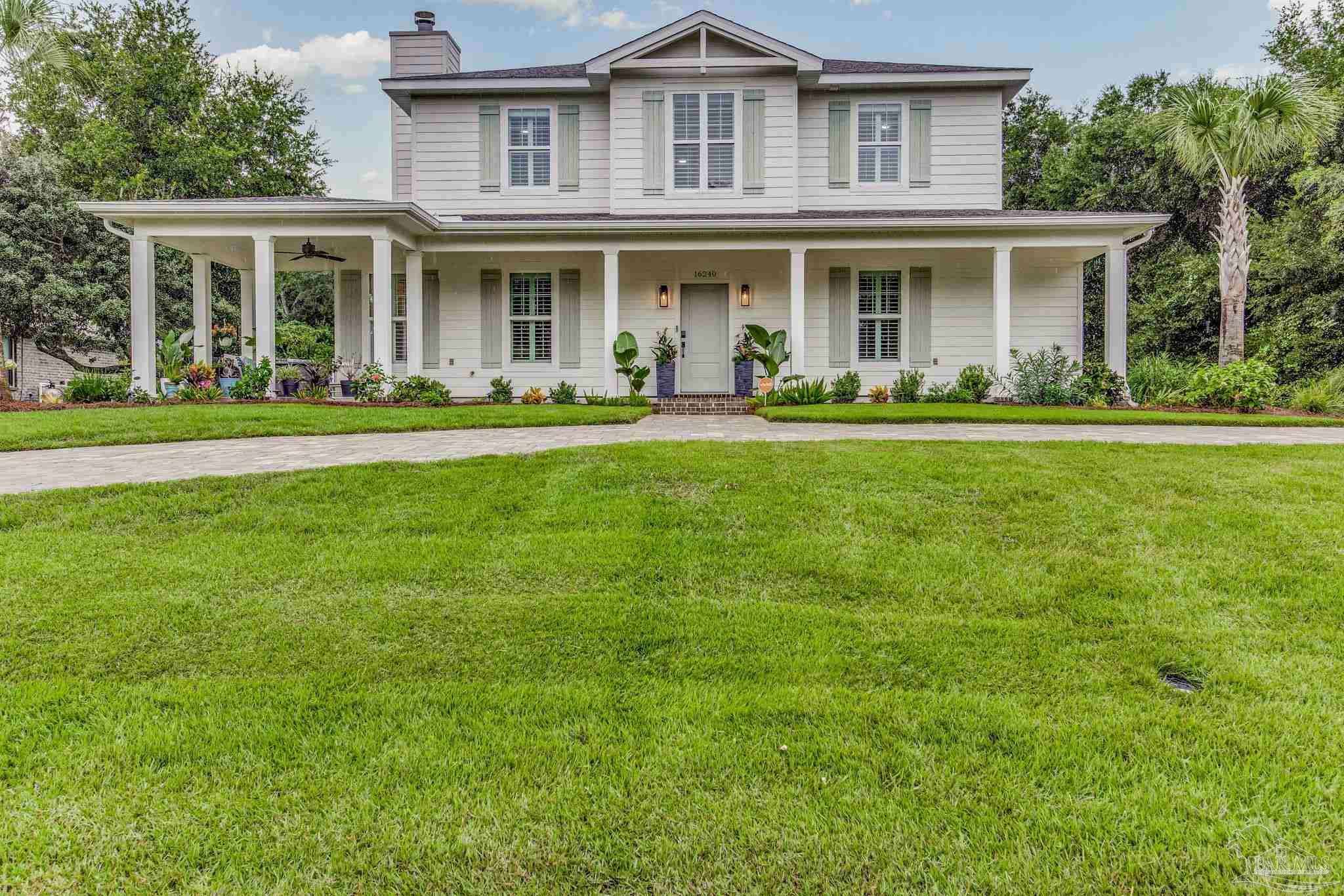 a front view of the house with yard and green space