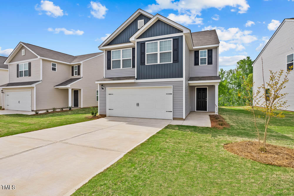 a front view of a house with a yard and garage