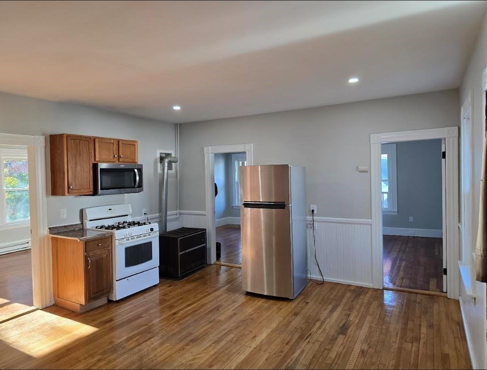 a kitchen with a refrigerator and a stove top oven