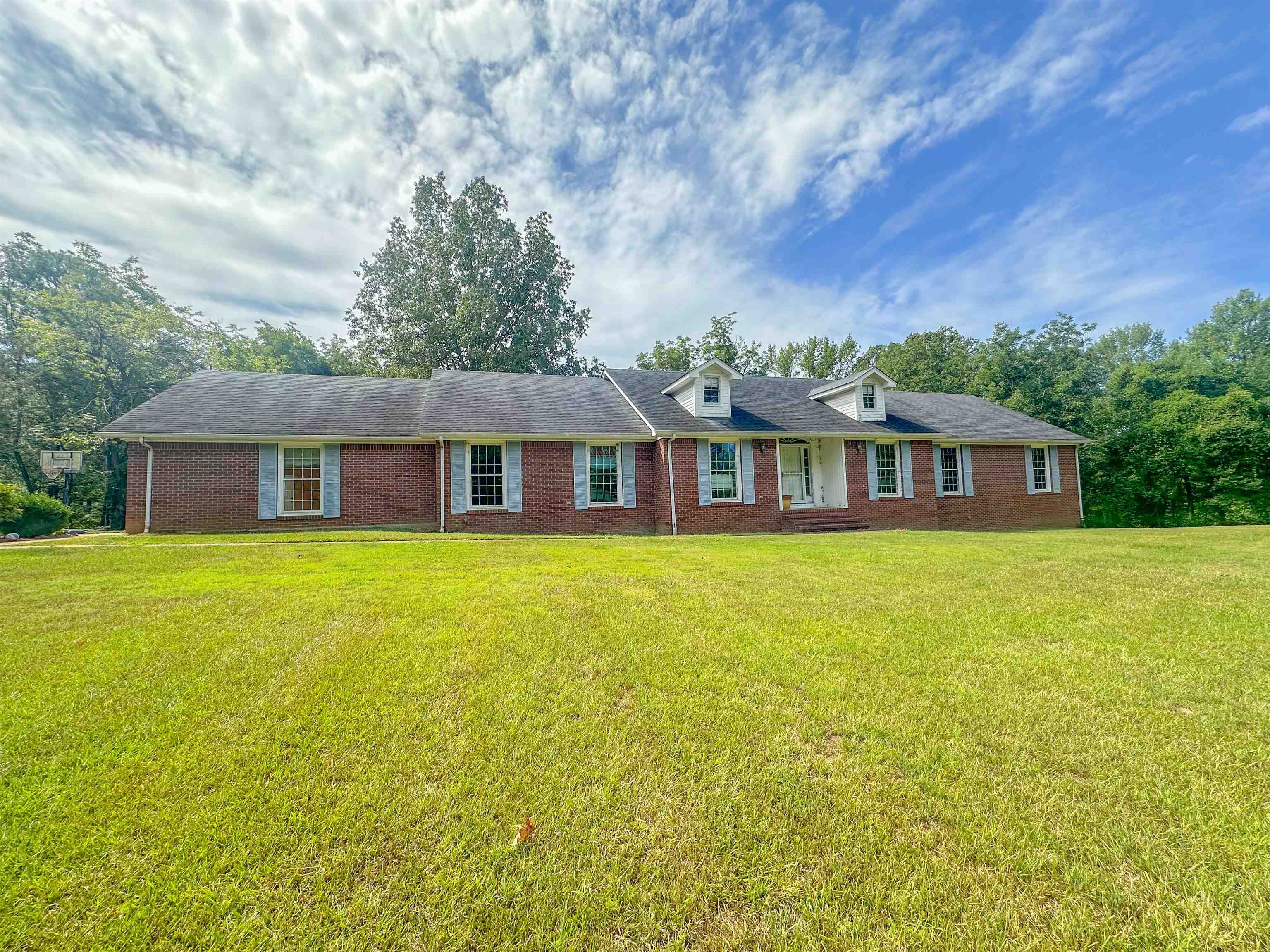 Single story home featuring a front lawn