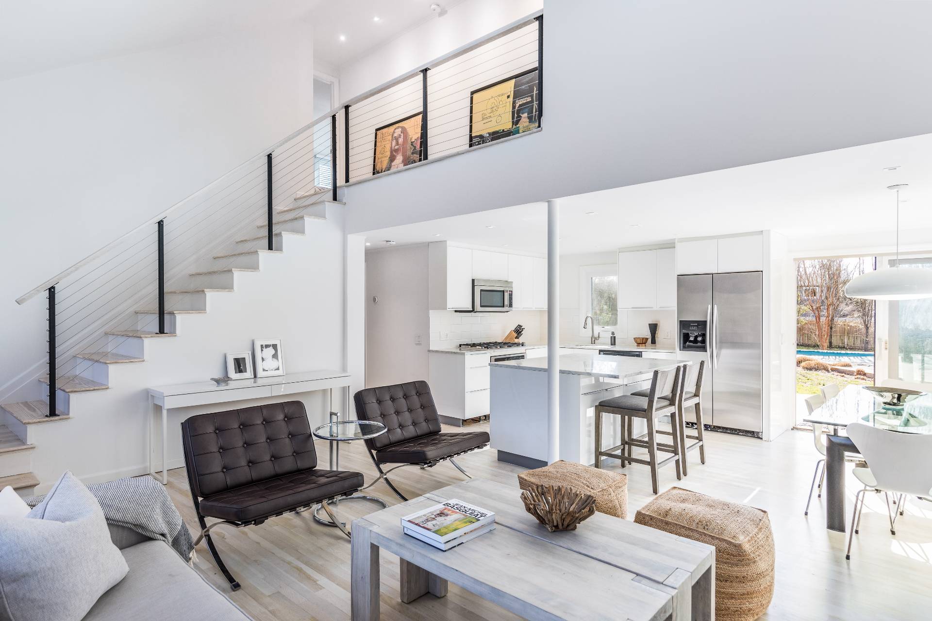 a living room with furniture a table and kitchen view