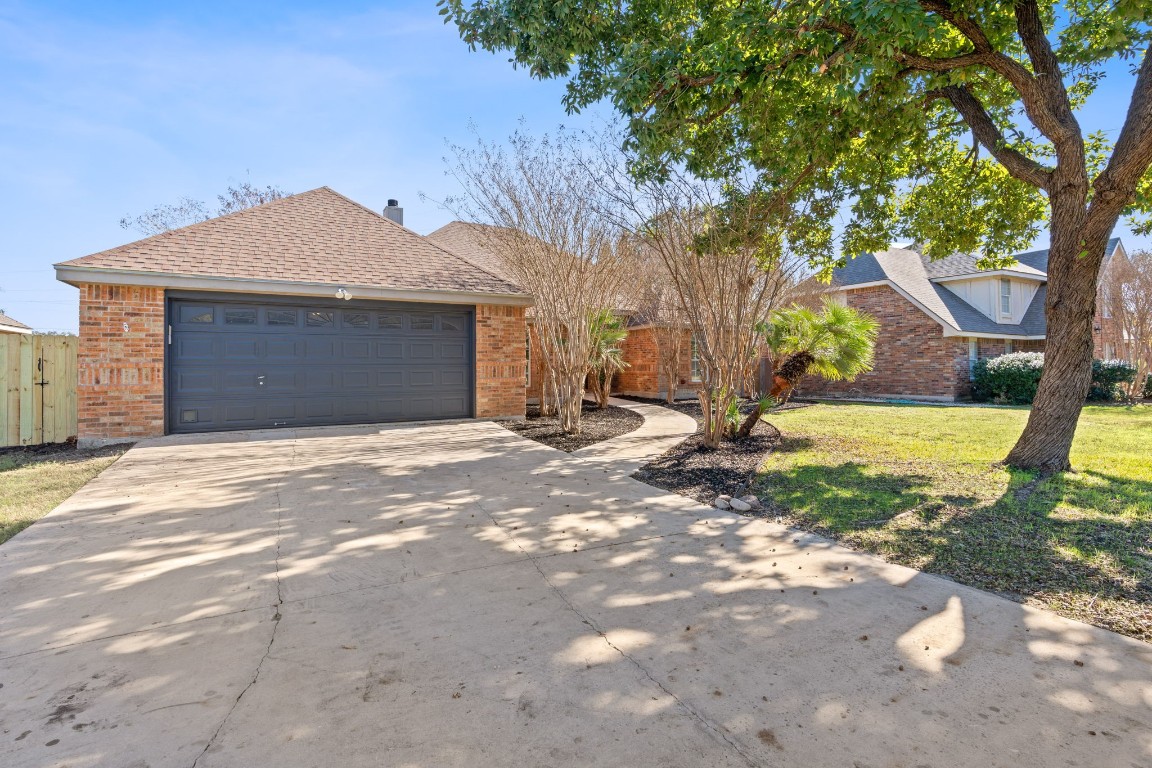 a view of a house with yard and tree s