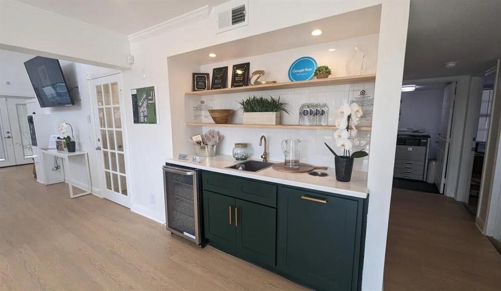 a kitchen with stainless steel appliances a sink and refrigerator