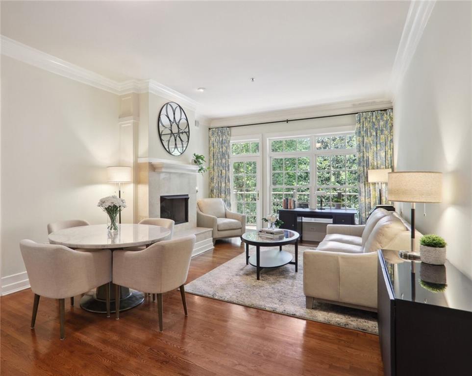 a living room with furniture a fireplace and a large window