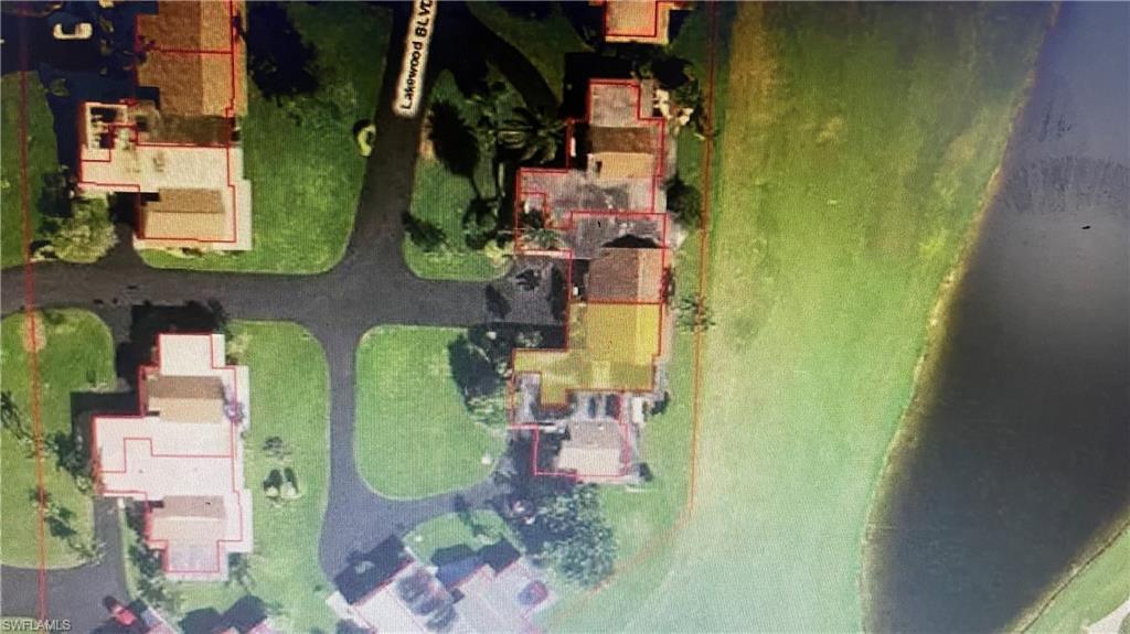 an aerial view of residential house with outdoor space and swimming pool