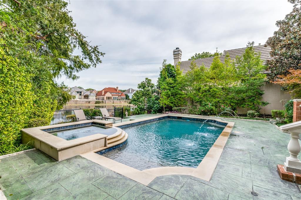 a view of swimming pool with outdoor seating and plants