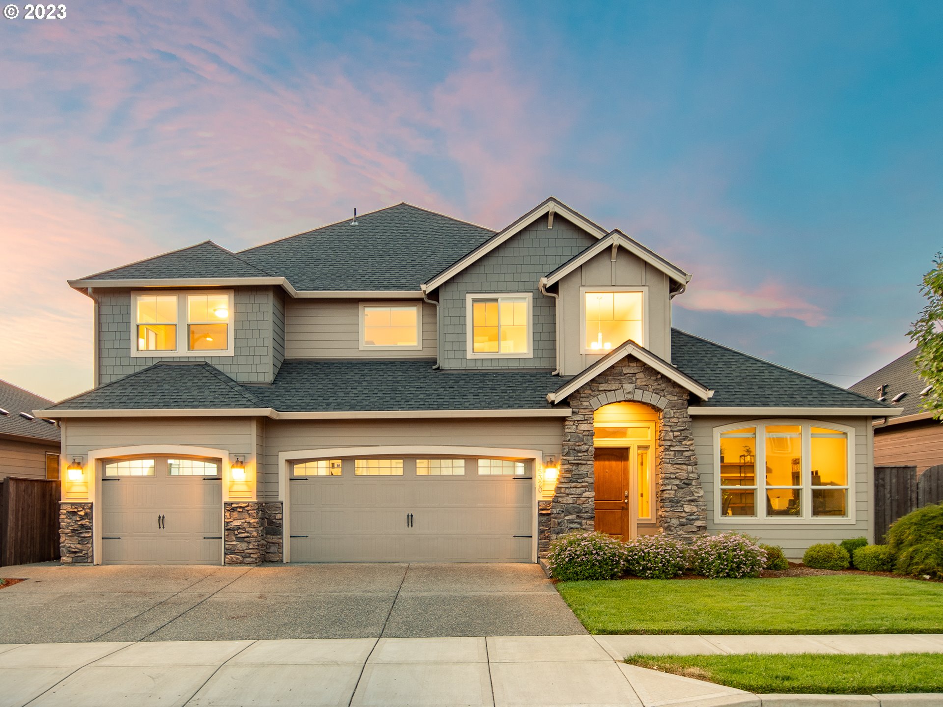 a front view of a house with a yard and garage