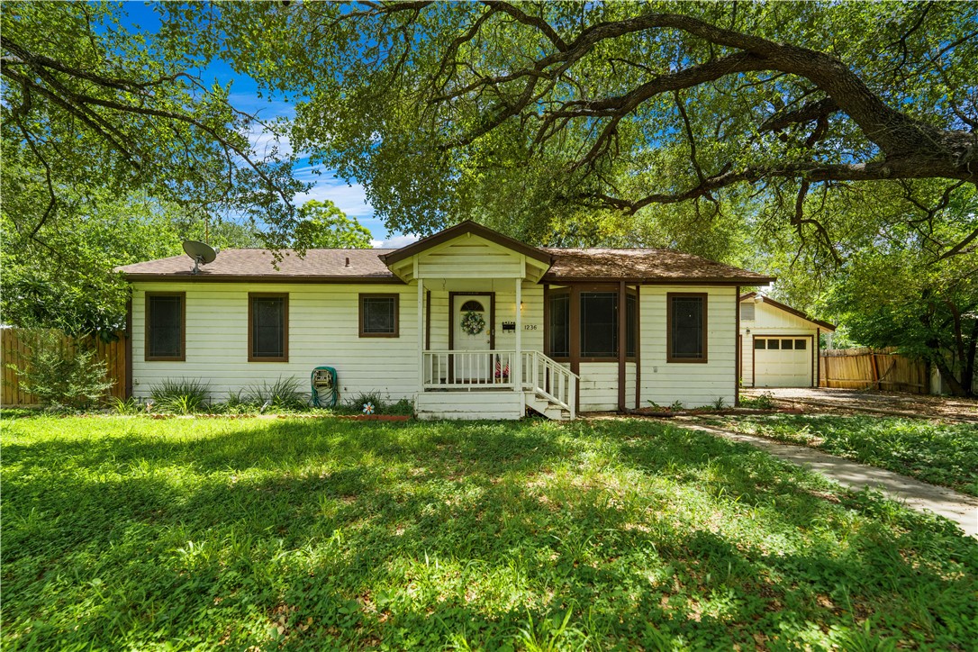 a big house with a big yard and large trees