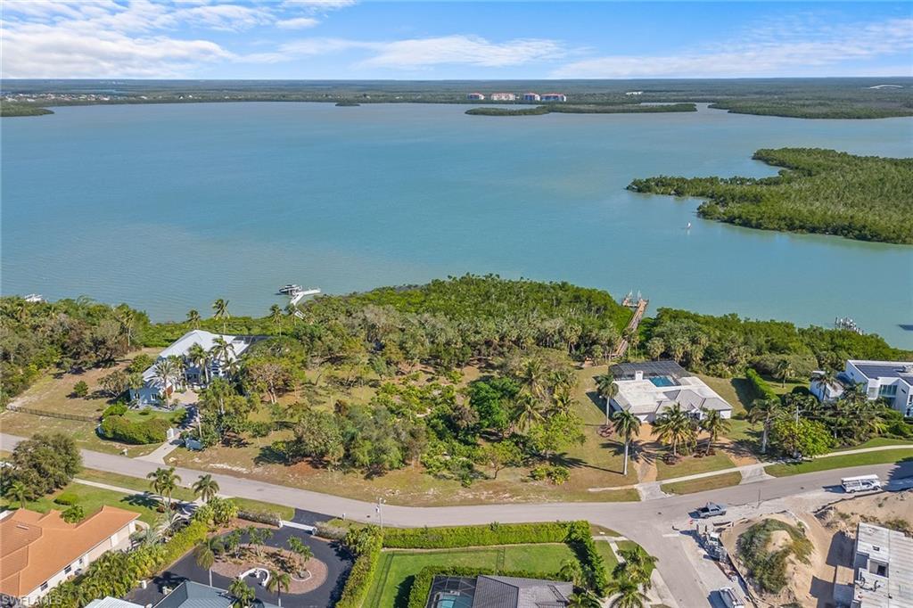 an aerial view of a houses with a lake