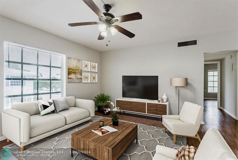 a living room with furniture and a flat screen tv