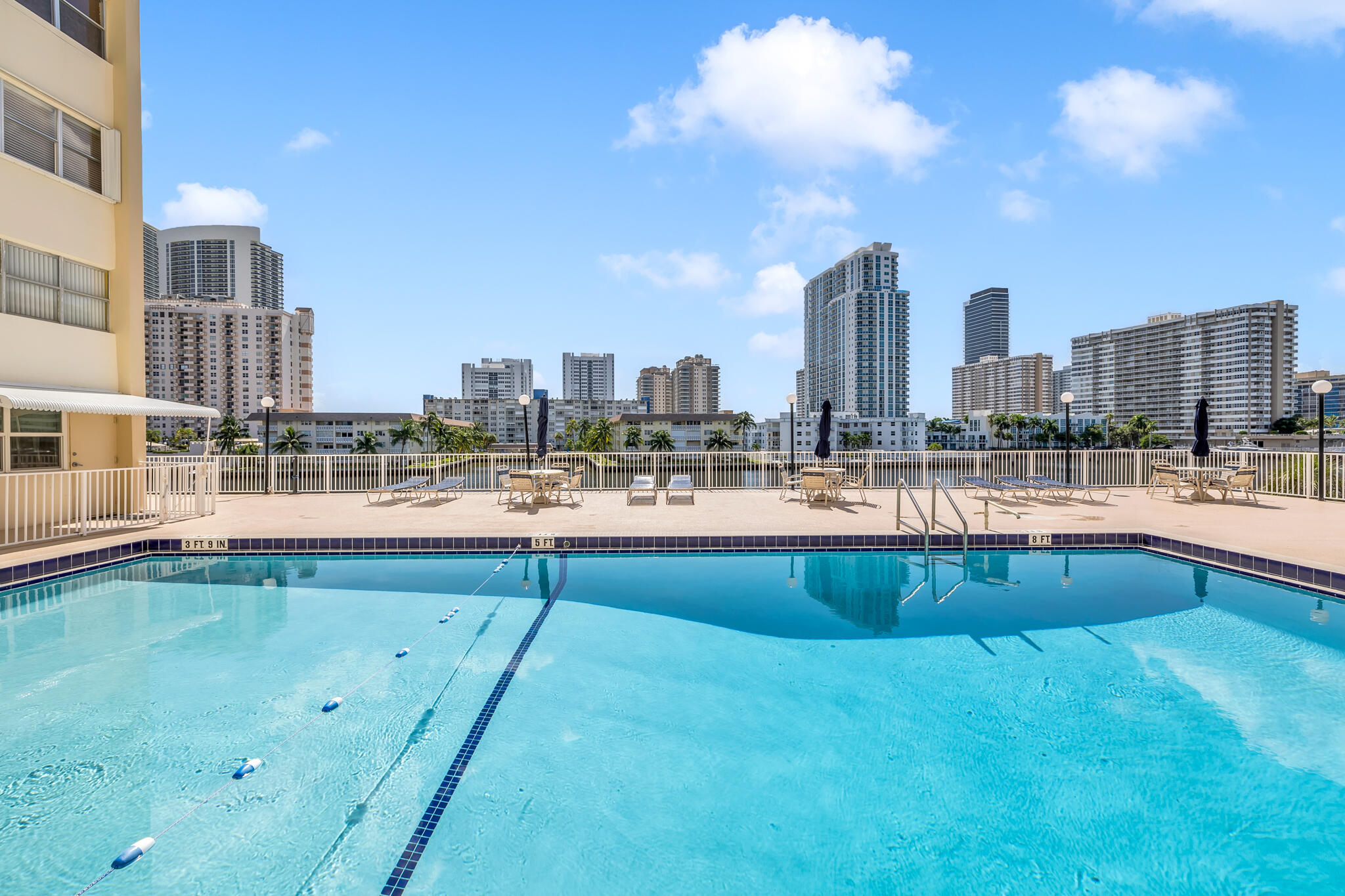 a large swimming pool with outdoor seating and yard