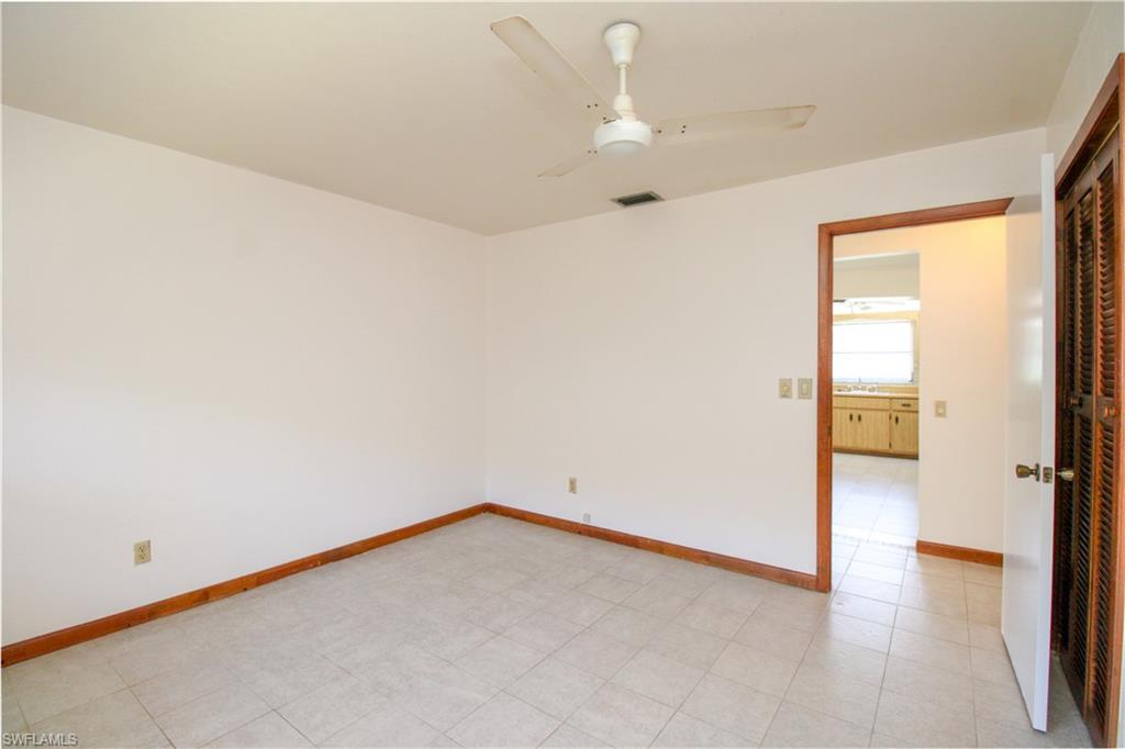 Empty room featuring ceiling fan and sink