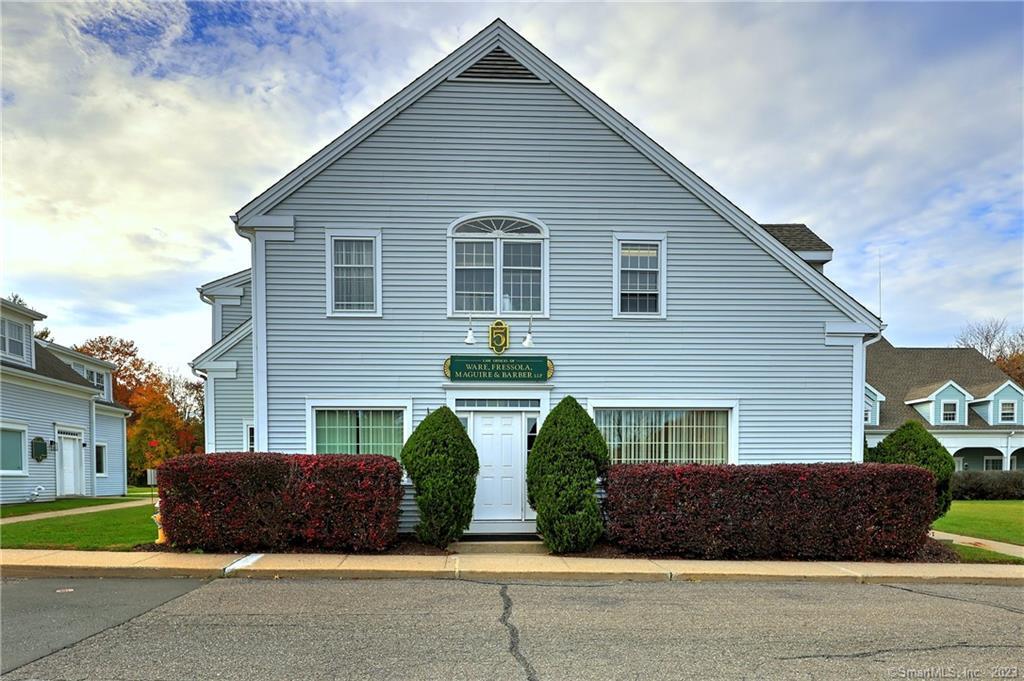 a front view of a house with garage and plants