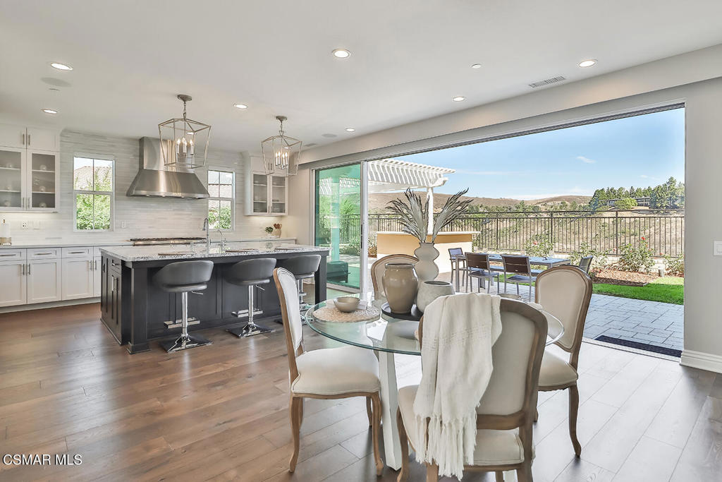 a dining room with furniture window and wooden floor