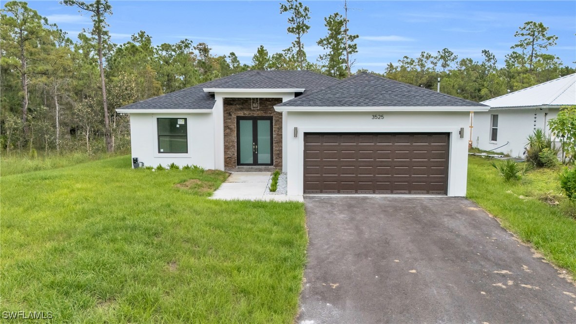 a front view of a house with a yard and garage