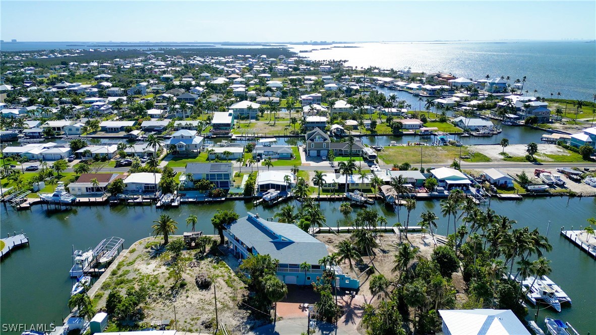 an aerial view of city and lake with trees all around