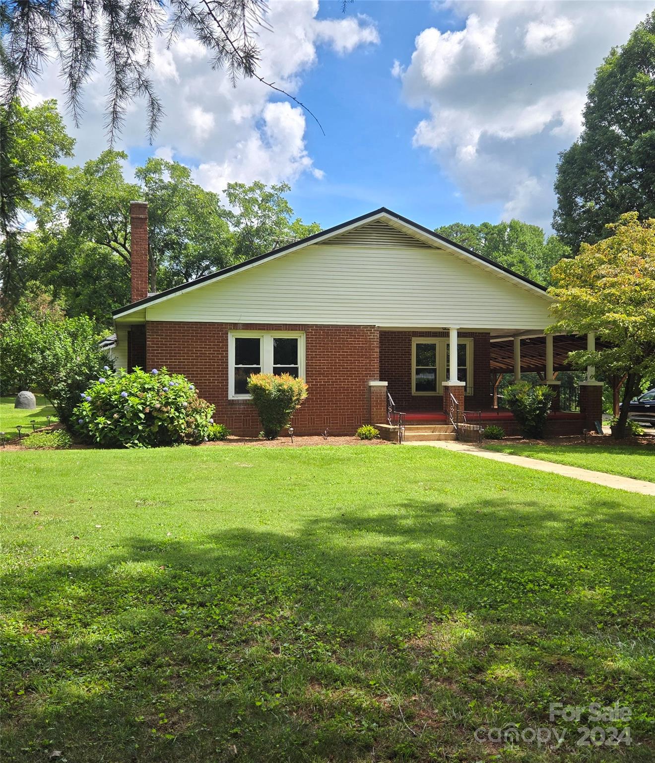 a front view of house with yard and green space