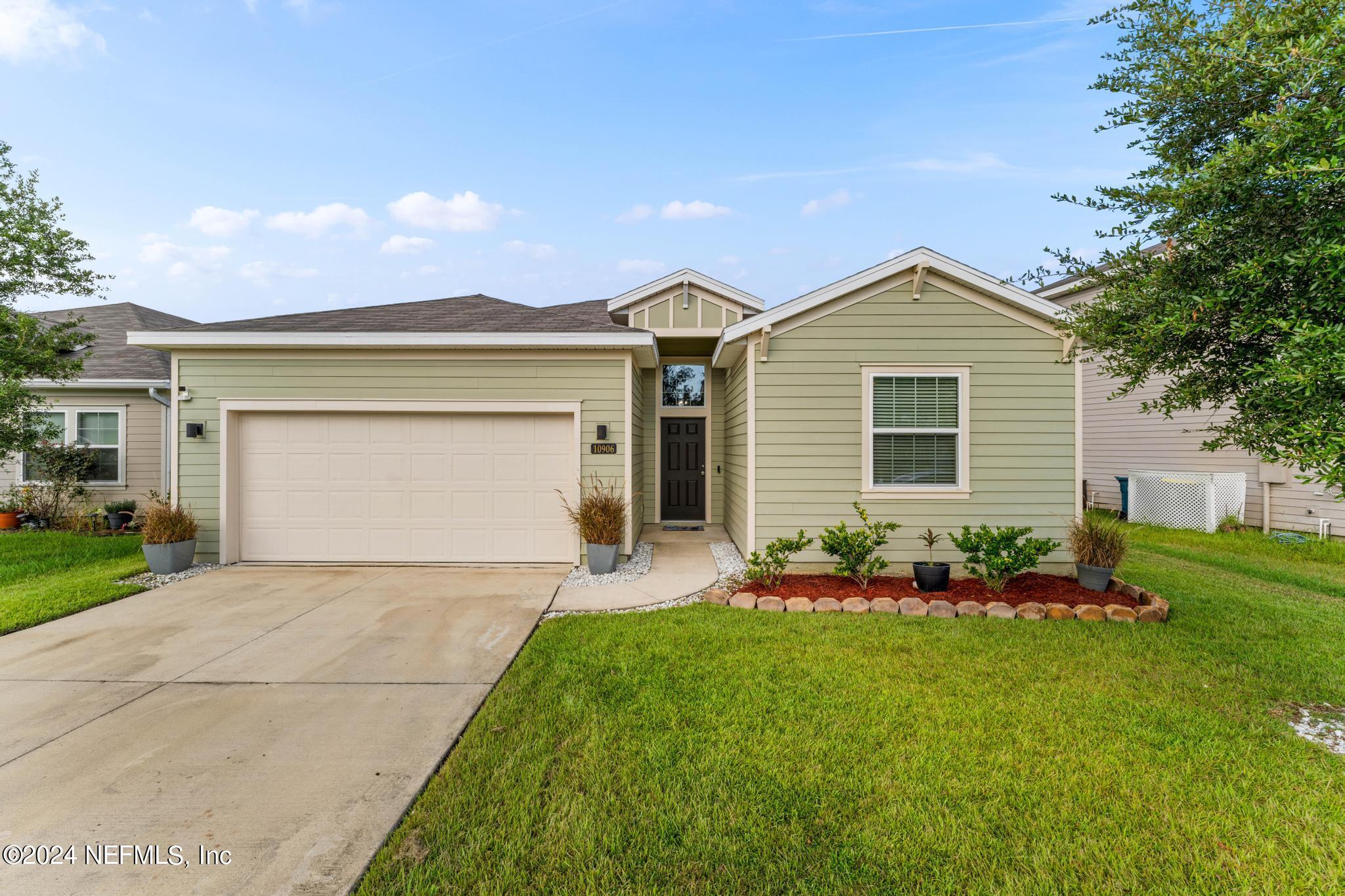 a front view of house with yard and green space