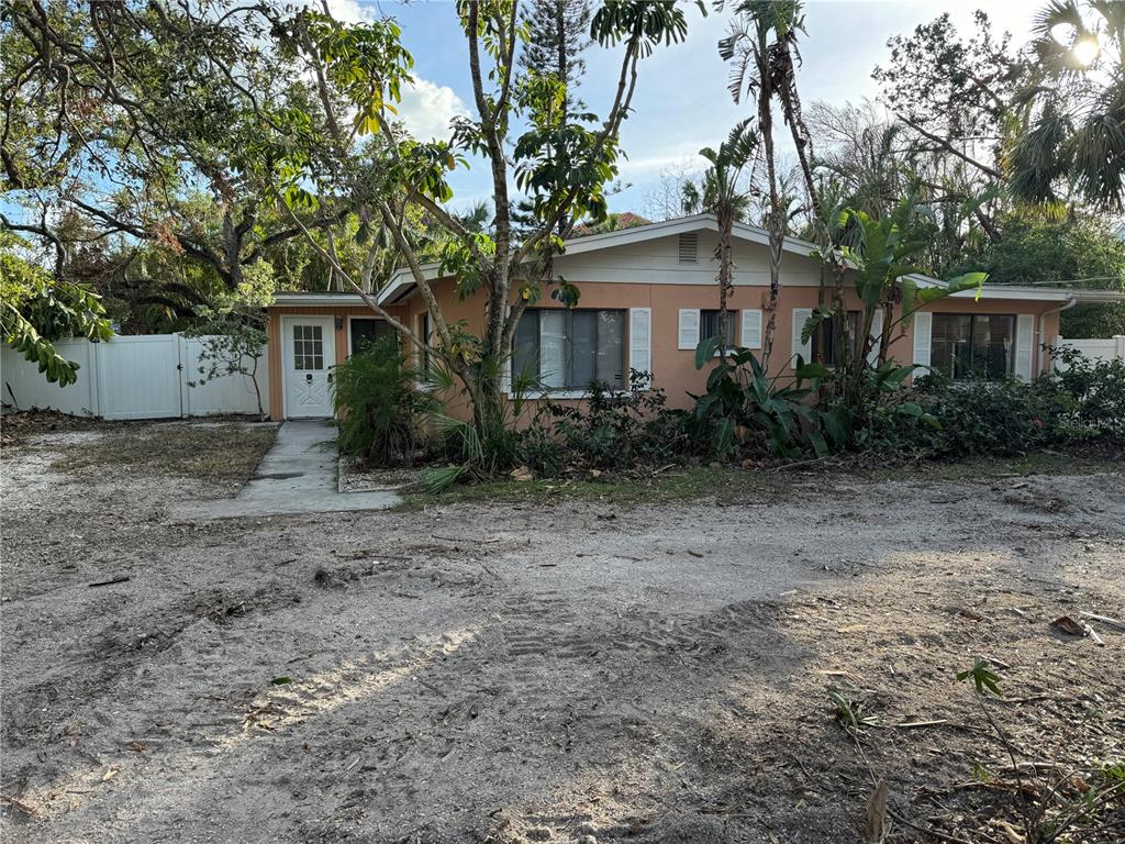 a view of a house with a tree in the background